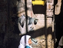 An Arab woman walks below a bird cage in the Arab district, Jerusalem.