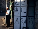 An Arab stands outside his Hebron shop.